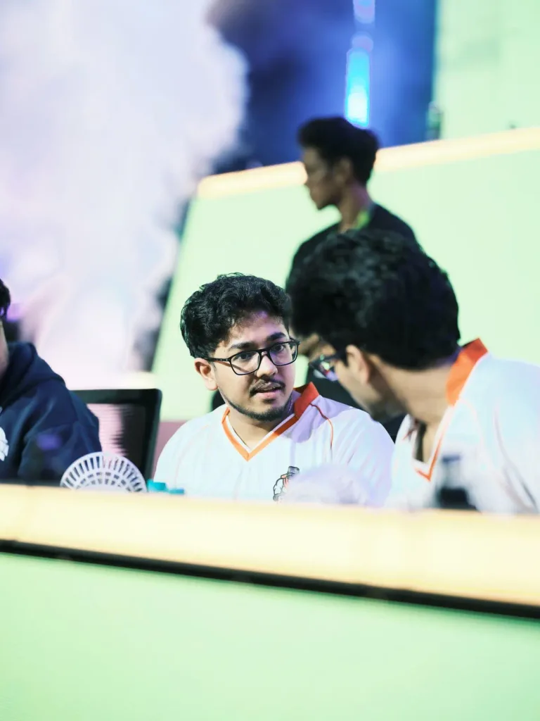 Team 8Bit's Sarang talks strategy with a teammate between matches. (Image via KRAFTON India)