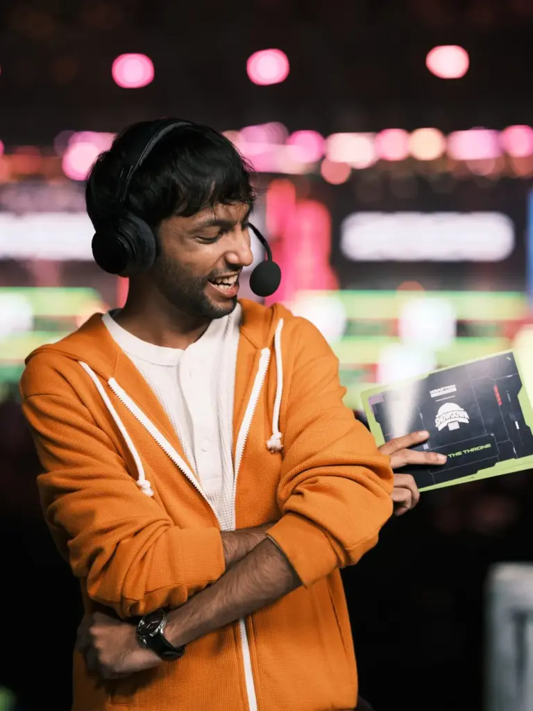 iSuperJonny, official English commentator and broadcast talent, shares a laugh at the casting desk. (Image via KRAFTON India)