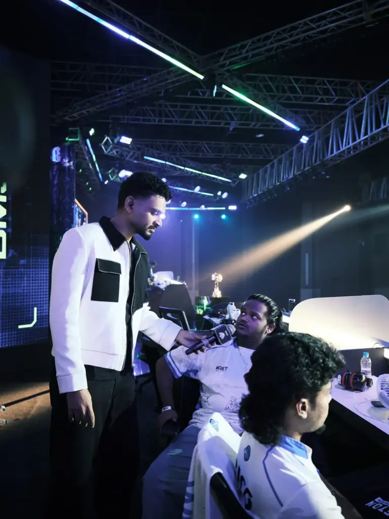 Host Rohit Varghese grabs a word with Meta Ninza's DragonOP at his booth. (Image via KRAFTON India)
