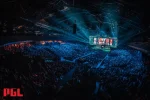 Atmospheric view of a packed esports arena during a major CS2 tournament, featuring vibrant blue lighting and a large crowd watching a central stage with multiple gaming screens displaying live action, highlighting the expansion to 32 teams in the competition